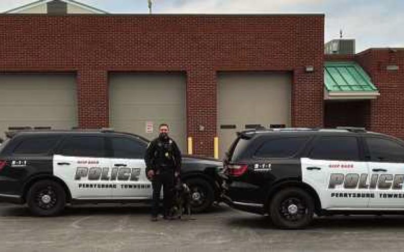 The K9 unit, from left: Ptl. Kurt Schroeder and K9 Maty, Ptl. Clayton Ringle and K9 Dyxo, Ptl. Nicholas Owens and K9 Rico.