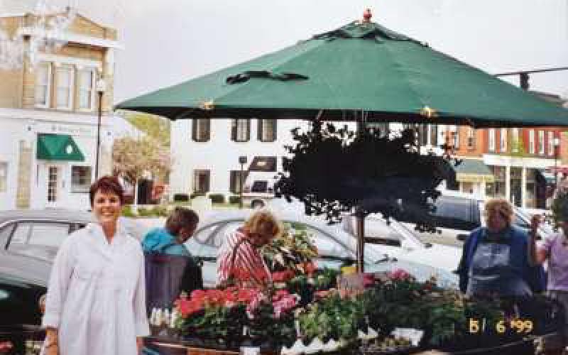 Vicki Stouffer stands next to one of the vendor spaces at the market in May 1999.