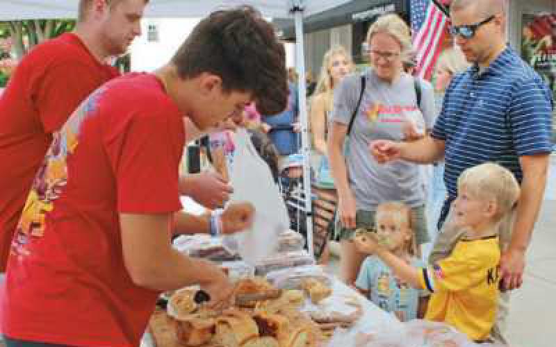 Fresh-baked bread is a popular treat at the market for people of all ages to enjoy.