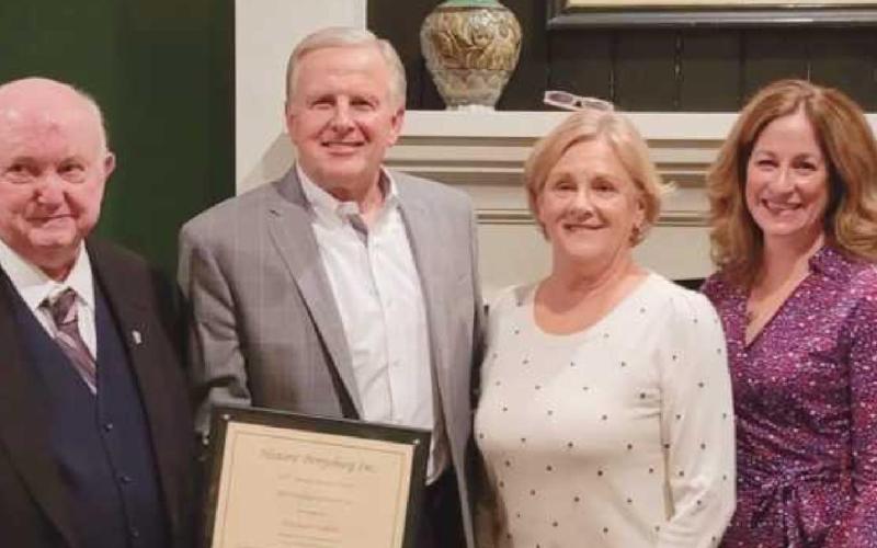 Joe Klein, first president of Historic Perrysburg Inc., presented the award to Allen Kazmaier and Mr. Kazmaier’s sister, Luana (Kazmaier) Croy. With them is, far right, current president of HPI, Rachael Davis. At right, Lou Hebert shares some stories of the hidden history of Perrysburg during the dinner.