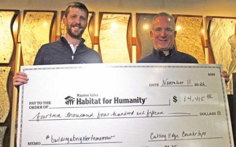 Left, Brian Burns, Cutting Edge Countertops co-owner and founding partner, presents a check to Michael McIntyre, Maumee Valley Habitat for Humanity executive director, on behalf of the tri-state region Habitat for Humanity locations.