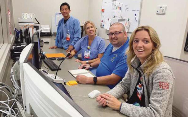 Members of the cath lab team explain process and teamwork to teacher Lauren Myers, RN; Adam Holcombe, Elmwood special education teacher; Tracey Jarrett, R.N., and John Mark Naila, R.N.