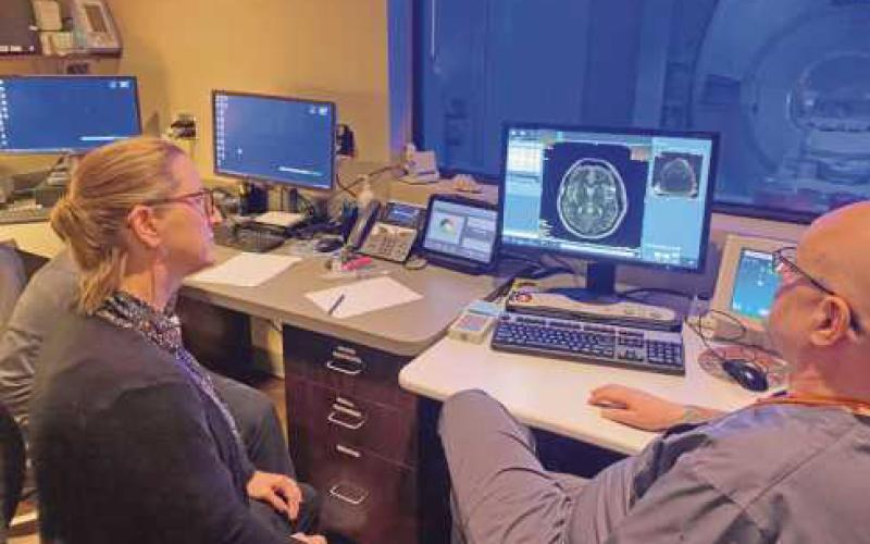 Teacher Stephanie Soltes hears about MRI scans from Aaron Konoff, lead imaging tech.
