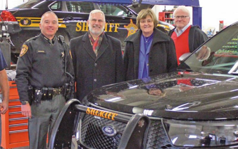 The new sheriff’s vehicles are being prepped before patrolling Wood County roads. Above from left are Chris Heinz, county garage supervisor; Sheriff Mark Wasylyshyn, and county commissioners Craig LaHote, Doris Herringshaw and Ted Bowlus.