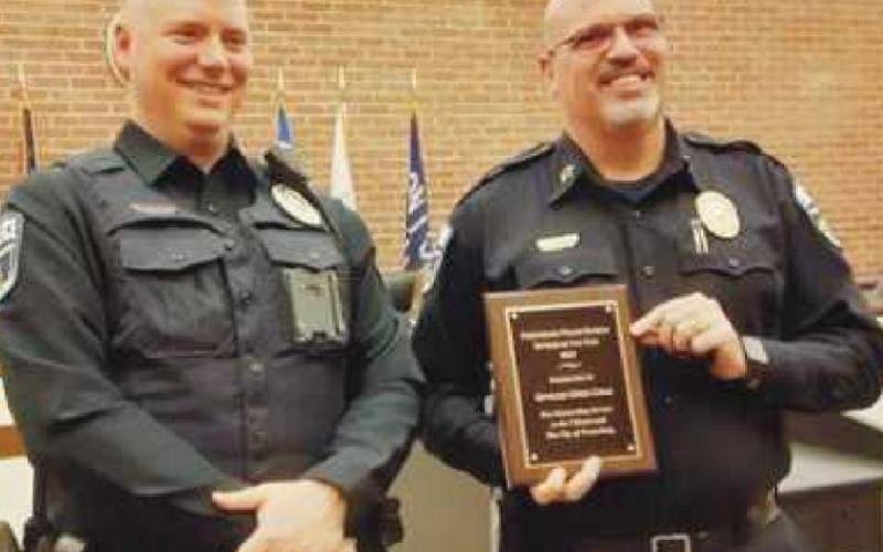 Chief Patrick Jones, right, presents Officer Greg Cole with the Officer of the Year award. Officer Cole is the school resource officer for Perrysburg High School.
