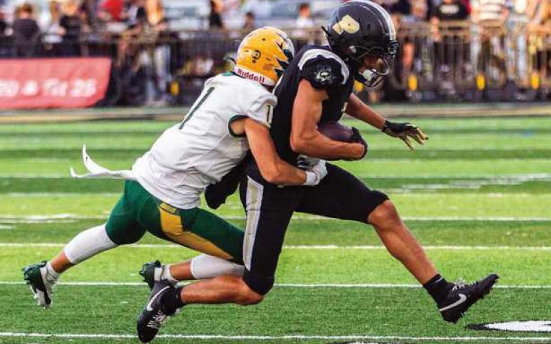 Senior Dominick Woods hauls in a pass before being tackled.