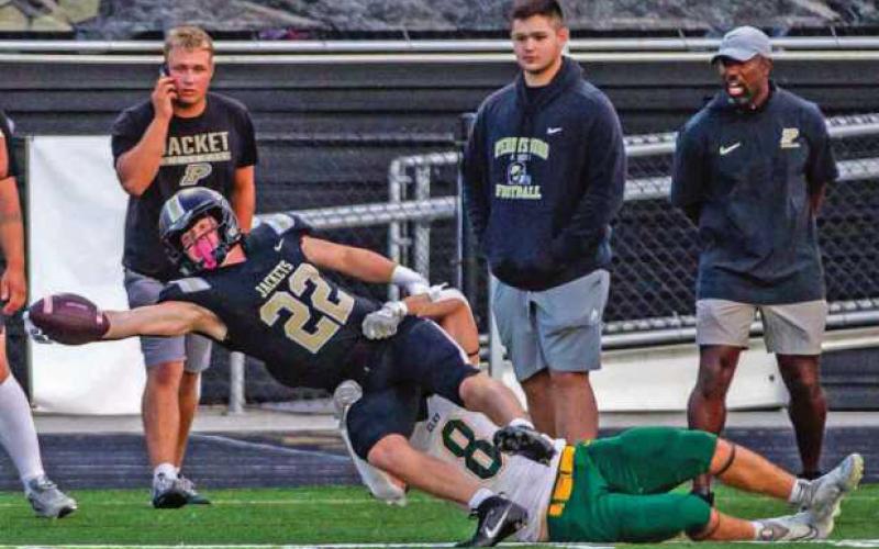 Senior Zach Schroeder stretches out in attempt to gain first down yardage.