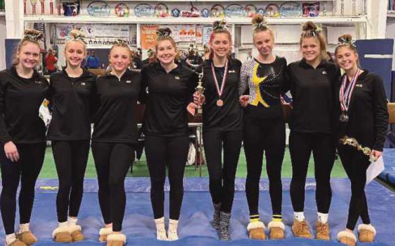 The varsity gymnasts, pictured above and below, took first place at the event to raise awareness for Duchenne Muscular Dystrophy.