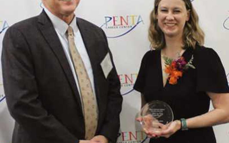 Perrysburg Superintendent Tom Hosler congratulates Alyssa Basham Johnson, a PHS Class of 2013 student, who was enrolled in Penta’s culinary arts program.