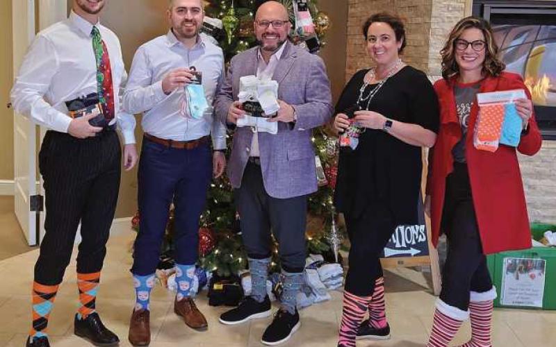 The Citizen Advisory Group team wearing crazy socks to kick off the sock drive.