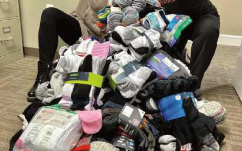 Sarah Bucher and Jordan Beach with some of the sock donations.