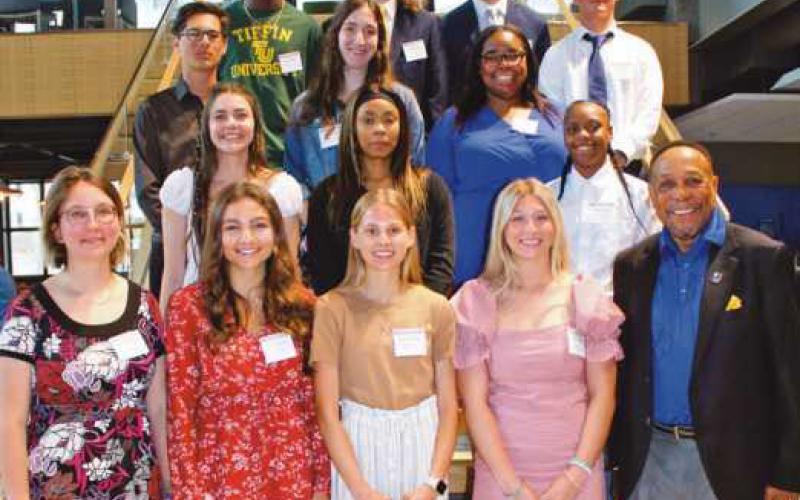 Above, with Chuck Ealey, are recipients of this year’s Undefeated Spirit scholarships, along with students who completed the mentoring program.