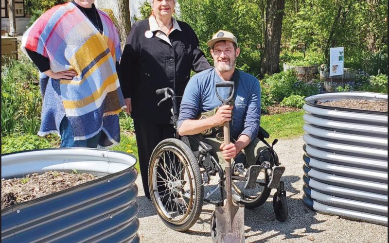 Pictured with two of the new, accessible garden beds are, from left: Heather Gallant, 577 executive director; Carol Lynn Wilson, Country Garden Club member, and Bennett Dowling, 577 organic landscape horticulturist.