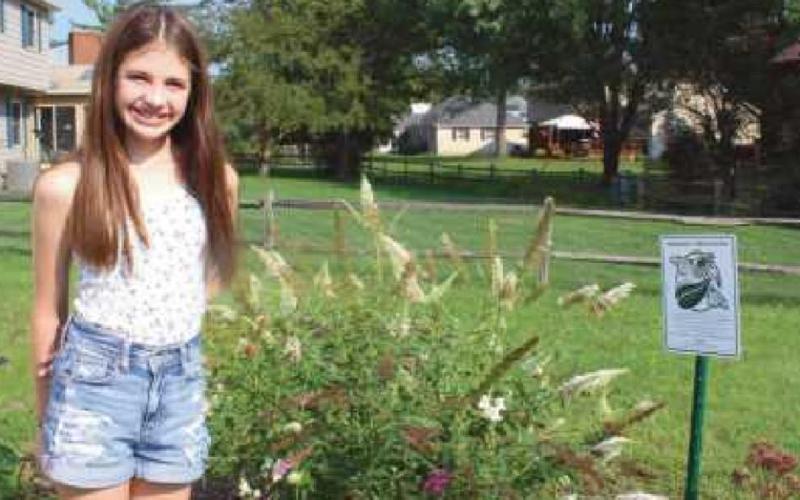 Top, Quinn among some of the many plants in her butterfly garden; middle, a butterfly at the garden; and bottom, the gardener next to a butterfly bush and the certification she received from Monarch Watch.