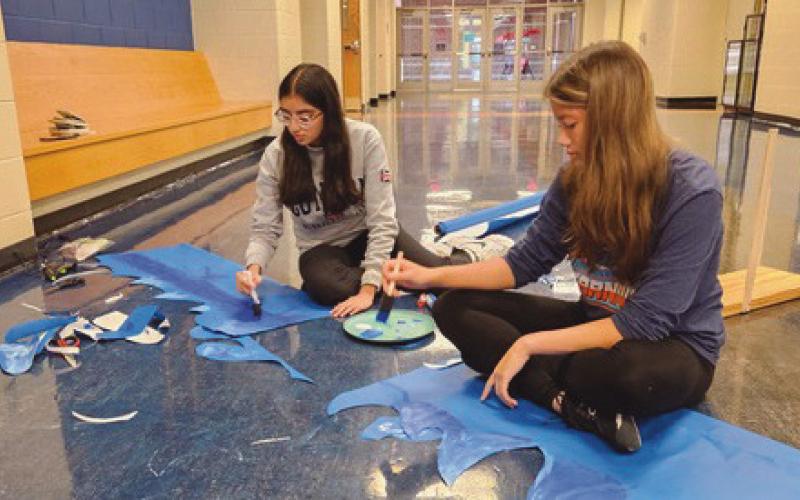 Drama Club members Bismah Gill and Iris Weisstein create items for the display case for “Peter and the Starcatcher.”