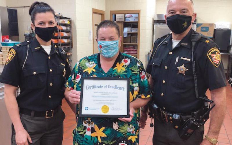 Captain Rebecca McMonigal, food service coordinator Sandy Snow and Wood County Sheriff Mark Wasylyshyn.