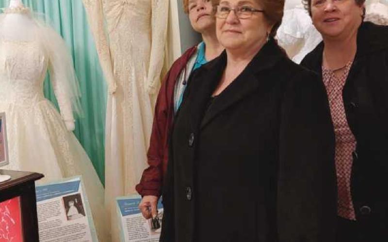 Carol Warnimont, center, is flanked by her daughters Julie and Cathy. Mrs. Warnimont’s dress is on the left and her aunt’s dress is on the right.