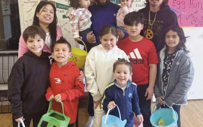 Families show off their Easter egg haul.