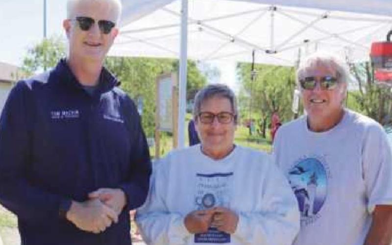 Mrs. Hagen, center, is flanked by Perrysburg Mayor Tom Mackin, left, and her husband at a recycling event.