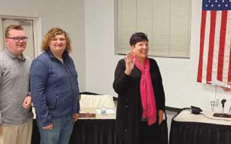 Lori Reffert was sworn in during the January 11 board meeting by treasurer Randy Drewyor. With her are her husband and sons, from left, Randy, Lucas and Ryan.