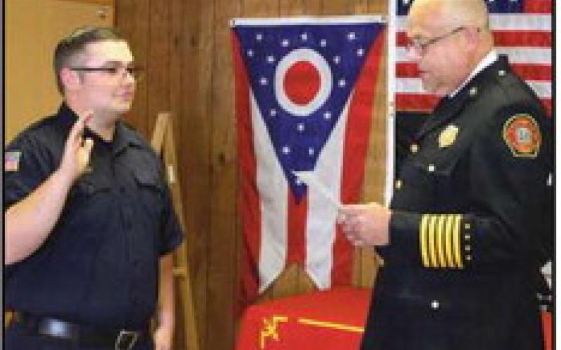 Fire Chief Tom Brice, right, swears in the newest full-time firefighter Jerod Wright. He began duty on September 9 with a starting hourly salary of $24.99.