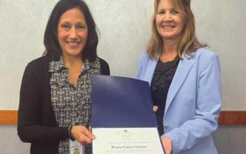 Penta Treasurer Carrie Herringshaw, left, accepts a perfect audit award from Lori Brodie of the auditor of state’s office.