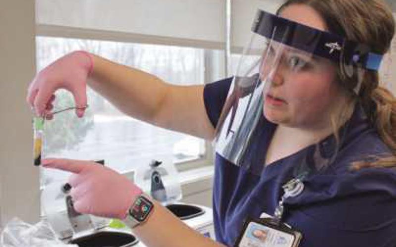 Hannah Guercio demonstrates how blood is separated in the centrifuge and the plasma extracted afterward. See drawing below.