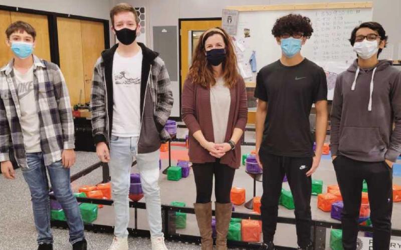 Instructor Lexi Marshall, center, in the STEM classroom with some of her students. “I never get bored,” she said. “Every day is different.”