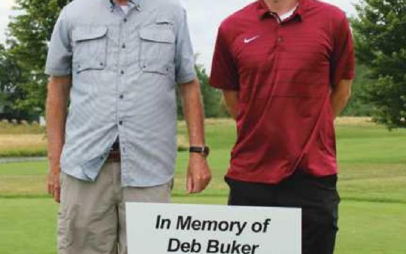 The 10th hole was dedicated to former Perrysburg Messenger Journal editor Deb Buker, a dog lover and huge supporter of the annual event, who passed away in 2020. Above are Mrs. Buker’s husband Les and son Scott.