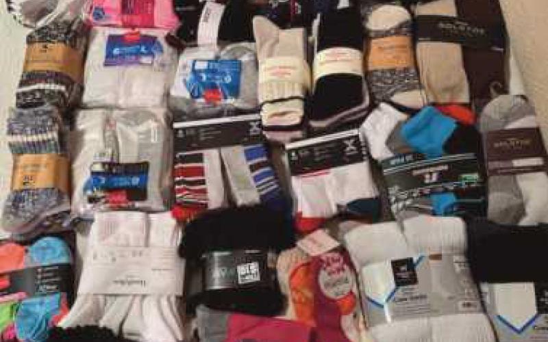 Monclova neighborhood hosts annual Christmas tree lighting, collects donations for Hannah’s Socks
