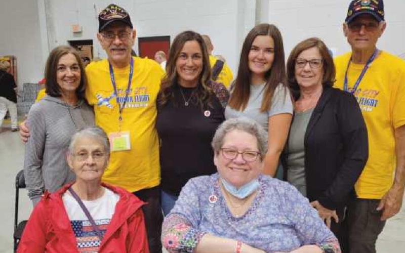 Veteran Robert Schwartz of Perrysburg and his brother-in-law veteran Todd Kissel of California, in yellow shirts, with their family members.