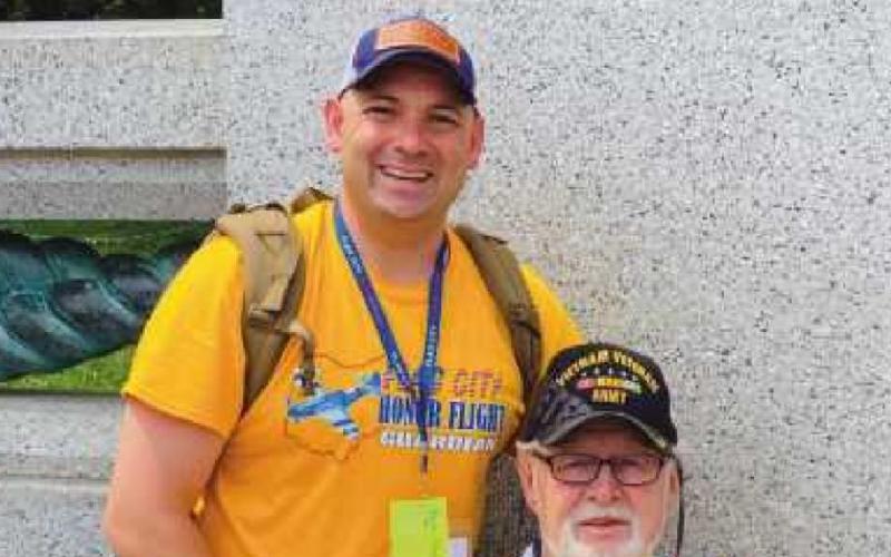 State Representative Haraz Ghanbari, left, a veteran himself, served as a guardian for U.S. Army veteran John McCabe, assisting him during the flight.