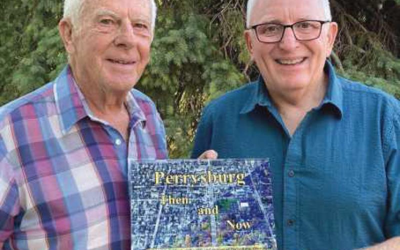 Local historians Gary Franks, left, and Mark Weber, have written “Perrysburg Then and Now.” It features photos of many notable locations around town from years ago in comparison to today, as shown on the page below.