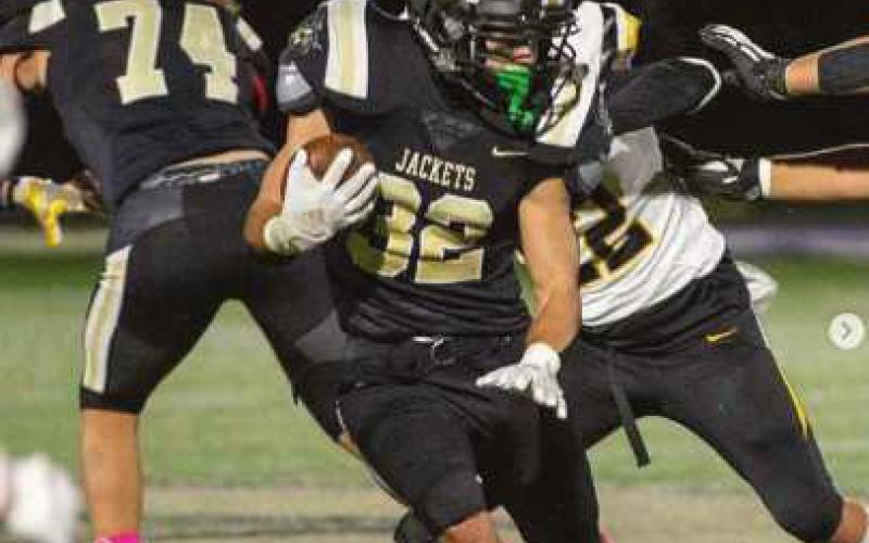 Runningback Joseph Seney scampers past the Wildcats. The Jackets wore pink socks for Breast Cancer Awareness month.