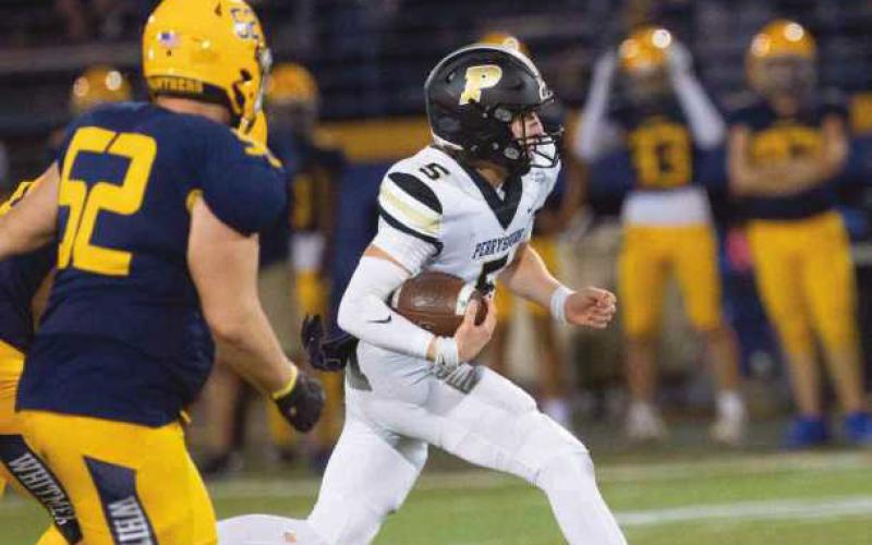 Quarterback Josh Takats finds running room, eluding the Panther defense.