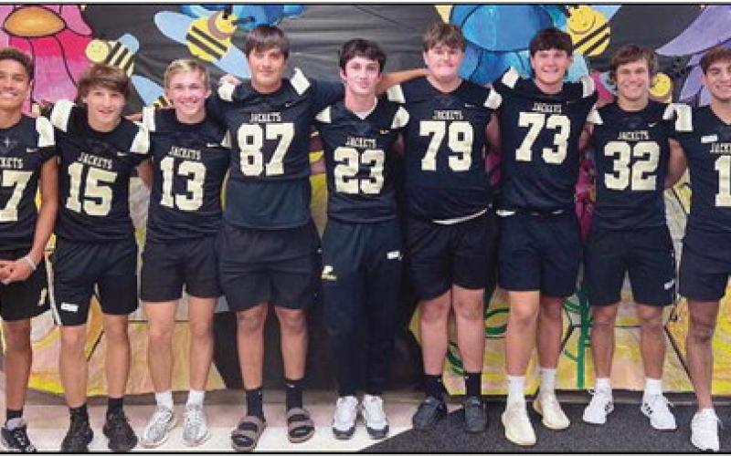 Football players visit Toth in Jacket Way program