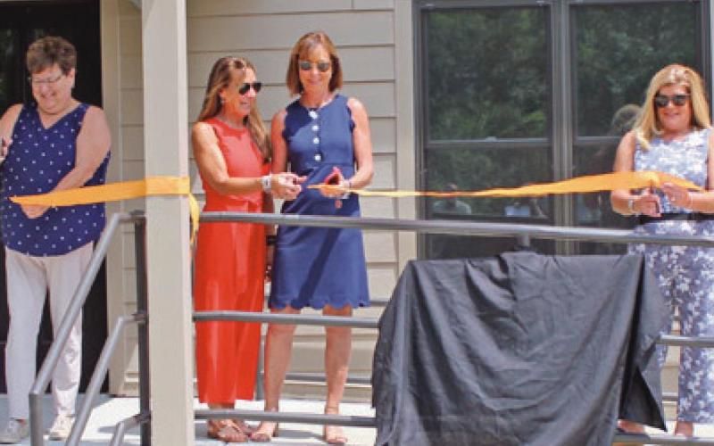 Members of the Sawyer family join Wood County Park District commissioners in dedicating the newly refurbished interpretive center at Sawyer Preserve on Lime City Road in Perrysburg Township. From left are Molly Sawyer Ludtke, park commissioner Sandy Wiechman, sisters Elizabeth Sawyer Biederman and Sally Sawyer Burns, and park commissioners Kim Rose and Tom Myers.