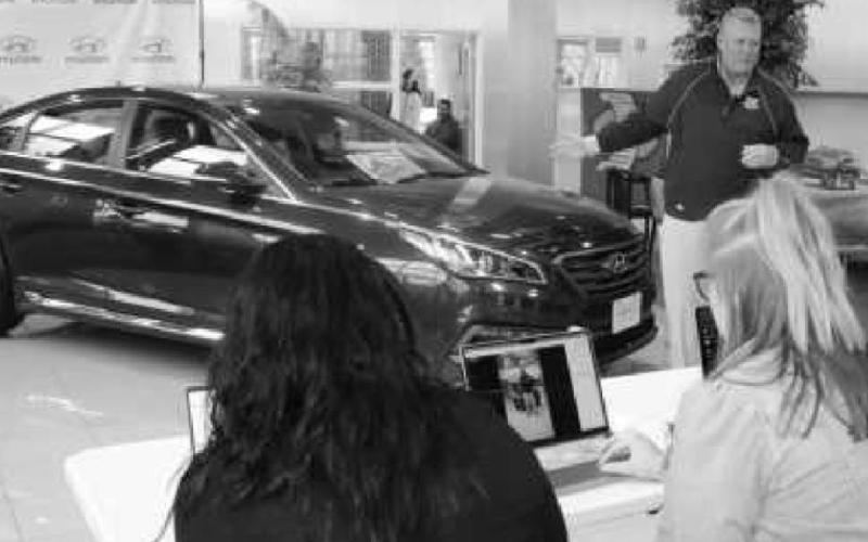 Steve Taylor with the 2015 Hyundai Sonata presented to the winner of the first Free Car Friday. With him are three Taylor employees who managed the random drawing.