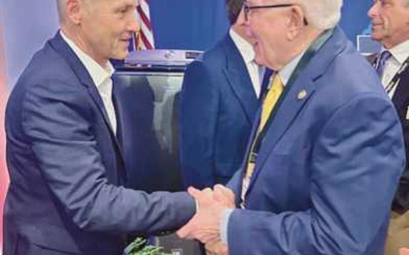 Mayor Mark Weber (right) shaking hands with Marc Bitzer (left), chairman and CEO of Whirlpool Corporation.
