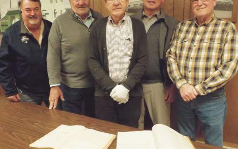 Plans are afoot for Perrysburg Township’s bicentennial in 2023. Pictured from left are: Jeff Justus, committee chairman; township trustees, Joe Schaller, Bob Mack, and Gary Britten. At center, Way Public Library local history librarian and committee co-chairman Richard Baranowski displays two township historical record books.