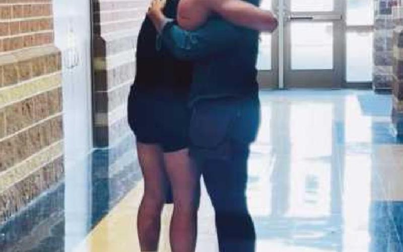 At right: Noah Ewen hugs his mom, Samantha, after qualifying for the OHSAA state wrestling tournament.