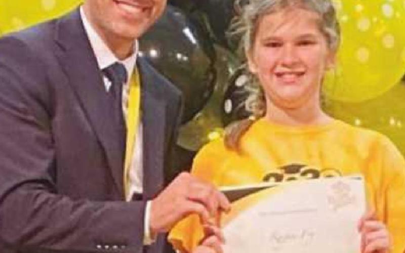 Lou Marconi, principal of Frank Elementary School, left, presents the Spirit of Frank Award to Ragan Fry.