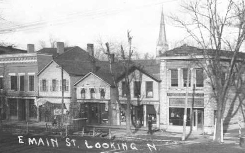 Addresses 125-131 Louisiana Avenue in 1910s. Note the barber pole and entrance to upstairs on the right.