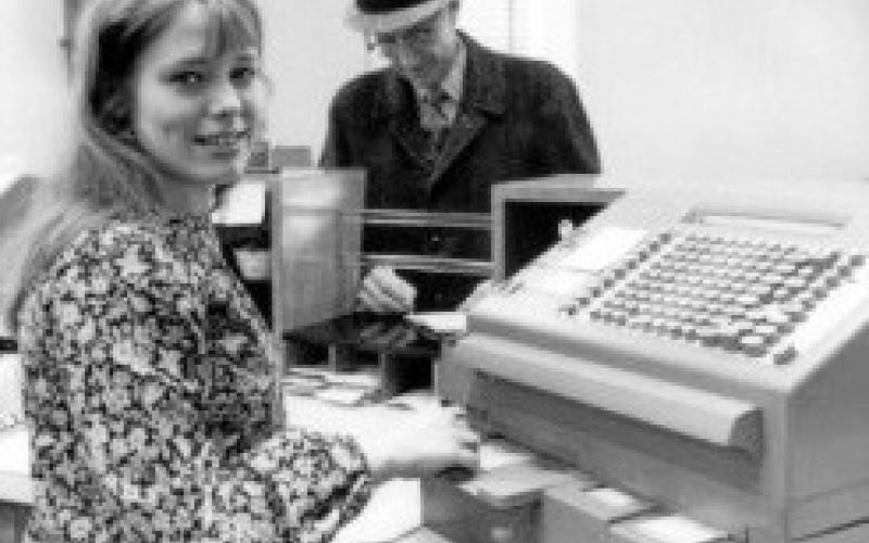 Bev (Myers) Ledbetter, at the uptown Huntington Bank, early 1970s. It is likely that is Pastor Elmer Melchert, Zoar Lutheran, at the counter.