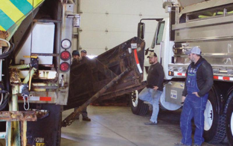 ODOT maintenance personnel inspect a wing plow.