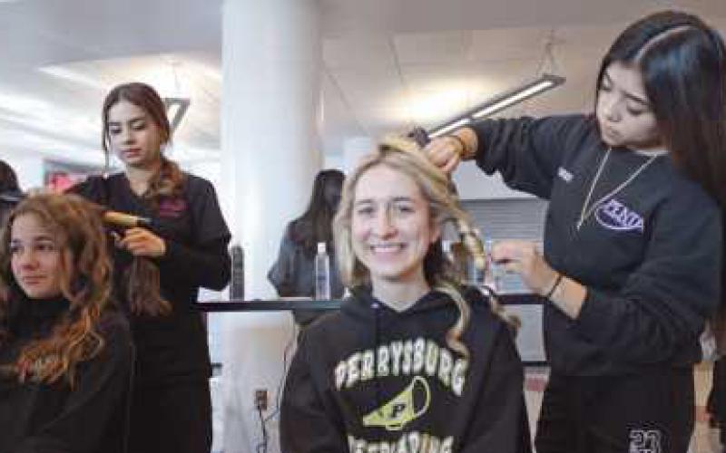 Georgia Von Deylen and Meredith Kulmatycki enjoy having their hair done at the cosmetology area.
