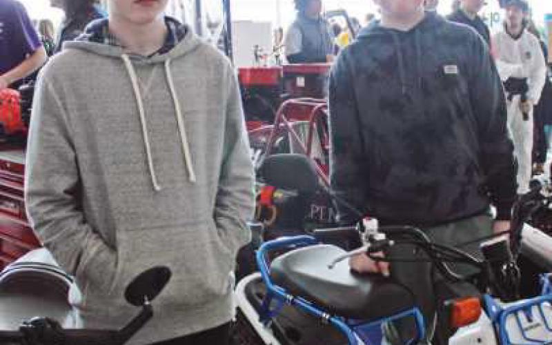 Collin Mackay and Parker Lemor check out Harley and Honda motorcycles at the automotive careers area.