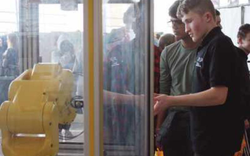 Ty Grayson, a Penta junior from Perrysburg schools, demonstrates robotics to Joel Nesamony.