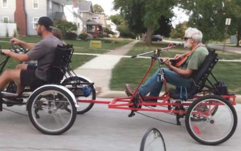 Jared Parseghian treats Bruce Brody to a ride so he can play guitar and sing.
