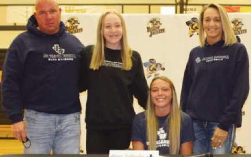 Morgan Featherstun will play basketball for John Carroll University where she will study exercise science. Pictured with her are her parents Loni and Kim and her sister, Brooke.